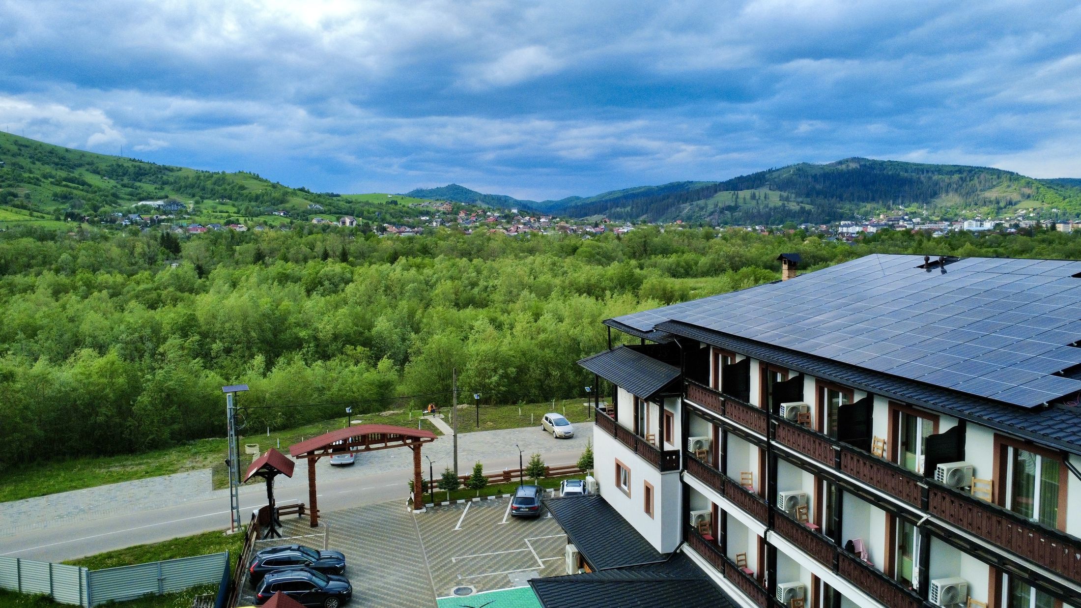 Aerial view of Hotel Casa Norbi in Voronet, Bucovina, Romania — surrounded by Carpathian mountains and forests